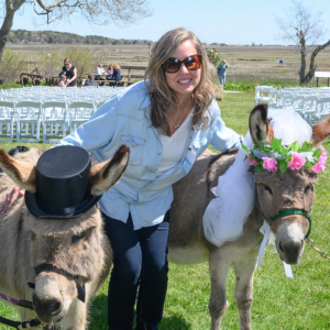 A Latham Friend takes photo with two-donkeys dressed for a "wedding."